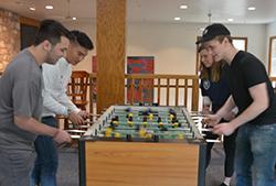 A round of foosball for old time's sake on Young 校友 Day.